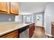 Bright kitchen area featuring wooden cabinets, stainless dishwasher, and an exterior door at 4413 Pinscher St, Union City, GA 30291