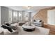 Cozy living room featuring a stone accent wall, hardwood floors, and a neutral color palette at 4413 Pinscher St, Union City, GA 30291