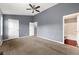 A large main bedroom with carpet, a ceiling fan, and an ensuite bathroom at 4413 Pinscher St, Union City, GA 30291