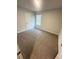Comfortable bedroom with natural light from a window and soft carpeting at 111 Deer Xing, Temple, GA 30179
