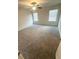 Bright and spacious bedroom with new carpet, ample natural light, and a ceiling fan at 111 Deer Xing, Temple, GA 30179