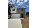 Charming two-story home features a two-car garage, brick facade, and landscaped front yard at 111 Deer Xing, Temple, GA 30179