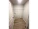 Functional laundry room featuring a storage shelf and hookups for a washer and dryer at 111 Deer Xing, Temple, GA 30179