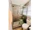 Modern shower with glass doors and a stylish tile pattern on the shower floor at 3420 Caley Mill Ln, Powder Springs, GA 30127