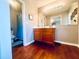 Bathroom with a large mirror and vanity with hardwood floors at 3420 Caley Mill Ln, Powder Springs, GA 30127