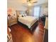 Bright bedroom featuring a large bed and hardwood floors at 3420 Caley Mill Ln, Powder Springs, GA 30127