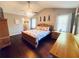 Bedroom with hardwood floors, a ceiling fan, and natural light from the windows at 3420 Caley Mill Ln, Powder Springs, GA 30127