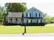 Charming two-story home with a well-manicured lawn and inviting front porch at 3420 Caley Mill Ln, Powder Springs, GA 30127