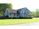 Two-story home featuring manicured lawn and an inviting front porch at 3420 Caley Mill Ln, Powder Springs, GA 30127