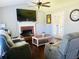 Bright living room showcasing fireplace, hardwood floors, and neutral wall color at 3420 Caley Mill Ln, Powder Springs, GA 30127