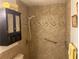 A full bath with tile walls, safety bars, and a handheld shower offering a safe and comfortable shower experience at 3546 Mount Vernon Ct, Lawrenceville, GA 30044