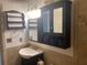 A full bath with a modern dark wood vanity, sink, wall cabinet and decorative shelving offering ample storage space at 3546 Mount Vernon Ct, Lawrenceville, GA 30044
