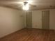 A neutral bedroom features wood-look flooring, a ceiling fan, and doors at 3546 Mount Vernon Ct, Lawrenceville, GA 30044