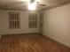 A spacious bedroom with beautiful wood floors, neutral walls, and a ceiling fan to keep you cool at 3546 Mount Vernon Ct, Lawrenceville, GA 30044