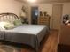 Comfortable bedroom features a full bath and closet, along with wood floors and soft lighting at 3546 Mount Vernon Ct, Lawrenceville, GA 30044