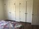 Bedroom with multiple closet doors featuring warm-toned floors and a comfortable place to relax at 3546 Mount Vernon Ct, Lawrenceville, GA 30044