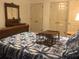 Comfortable bedroom featuring a patterned bedspread and antique furniture, enhancing its charm at 3546 Mount Vernon Ct, Lawrenceville, GA 30044
