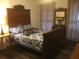 Bedroom featuring a large wooden bed frame, unique decor, and hardwood floors at 3546 Mount Vernon Ct, Lawrenceville, GA 30044