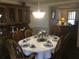 Elegant dining room set for a formal dinner, featuring a large hutch at 3546 Mount Vernon Ct, Lawrenceville, GA 30044