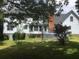 Charming home exterior with a brick chimney, wooden deck, and landscaped yard at 3546 Mount Vernon Ct, Lawrenceville, GA 30044
