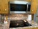 Modern kitchen with smooth cooktop, stainless steel microwave, and unique decor at 3546 Mount Vernon Ct, Lawrenceville, GA 30044