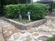 Beautiful stone-paved yard with a decorative stone planter and lush greenery at 3546 Mount Vernon Ct, Lawrenceville, GA 30044