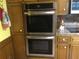 Built-in double oven with stainless steel trim set into wooden cabinetry at 3546 Mount Vernon Ct, Lawrenceville, GA 30044
