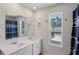 Bright bathroom featuring double sinks with vanity and a window offering natural light at 5123 Tulip Sq, Acworth, GA 30101