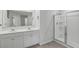 Modern bathroom featuring a double sink vanity and glass-enclosed shower at 5123 Tulip Sq, Acworth, GA 30101
