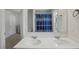 Bathroom featuring a double sink vanity with white cabinets and a shower/tub combo at 5123 Tulip Sq, Acworth, GA 30101