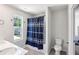 Bathroom featuring a double sink vanity and a shower/tub combo with patterned curtain at 5123 Tulip Sq, Acworth, GA 30101