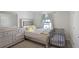 Bedroom featuring a bed, crib, dresser, and a window with natural light at 5123 Tulip Sq, Acworth, GA 30101