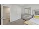Light-filled bedroom featuring an organized walk-in closet and a gleaming silver dresser at 5123 Tulip Sq, Acworth, GA 30101