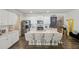 Bright kitchen with white cabinets, stainless steel appliances, large island, and four bar stools at 5123 Tulip Sq, Acworth, GA 30101