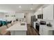 Well-lit kitchen featuring stainless steel appliances, white cabinets, and an adjacent dining area at 5123 Tulip Sq, Acworth, GA 30101