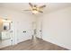 Well-lit bedroom featuring hardwood floors, a ceiling fan, and an ensuite bathroom at 560 Fisher Dr # 48, Alpharetta, GA 30009