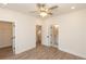 Bedroom featuring light wood-look floors, ceiling fan, closet, and ensuite bathroom with white doors at 560 Fisher Dr # 48, Alpharetta, GA 30009