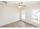 Bright bedroom with hardwood floors, ceiling fan, and two windows overlooking the yard at 560 Fisher Dr # 48, Alpharetta, GA 30009