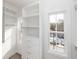Well-organized walk-in closet with built-in shelving, drawers, and natural light at 560 Fisher Dr # 48, Alpharetta, GA 30009
