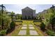 Beautiful community space featuring a manicured lawn, garden, benches, and a pergola at 560 Fisher Dr # 48, Alpharetta, GA 30009