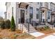 Attractive townhome showcasing a brick facade, black accents, and manicured landscaping at 560 Fisher Dr # 48, Alpharetta, GA 30009