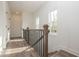 Bright upstairs hallway with wood floors, white wainscoting, and black door hardware at 560 Fisher Dr # 48, Alpharetta, GA 30009