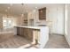 Bright kitchen featuring a large island, stylish pendant lights, and sleek countertops at 560 Fisher Dr # 48, Alpharetta, GA 30009