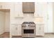 Well-lit kitchen features white cabinets, stainless steel appliances, and a marble backsplash at 560 Fisher Dr # 48, Alpharetta, GA 30009