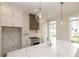 Bright kitchen boasts marble counters, a stainless steel range, and pendant lighting at 560 Fisher Dr # 48, Alpharetta, GA 30009