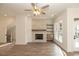 Living room boasts a brick fireplace, wood floors, and multiple windows at 560 Fisher Dr # 48, Alpharetta, GA 30009