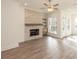 Living room with a ceiling fan showcases a stone fireplace and wood floors at 560 Fisher Dr # 48, Alpharetta, GA 30009