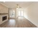 Inviting living room features a stone fireplace, wood floors, and large windows at 560 Fisher Dr # 48, Alpharetta, GA 30009