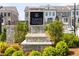 Stone sign for Towns on Thompson with landscaping and townhomes in the background at 560 Fisher Dr # 48, Alpharetta, GA 30009