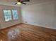 Bedroom featuring hardwood floors, a large window, and neutral wall color at 6419 Edenfield Dr, Lithonia, GA 30058